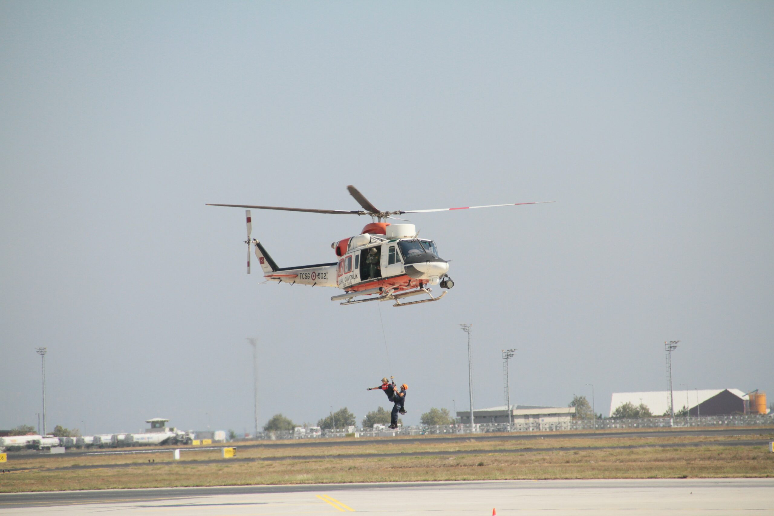 A person on a stretcher being airlifted by helicopter