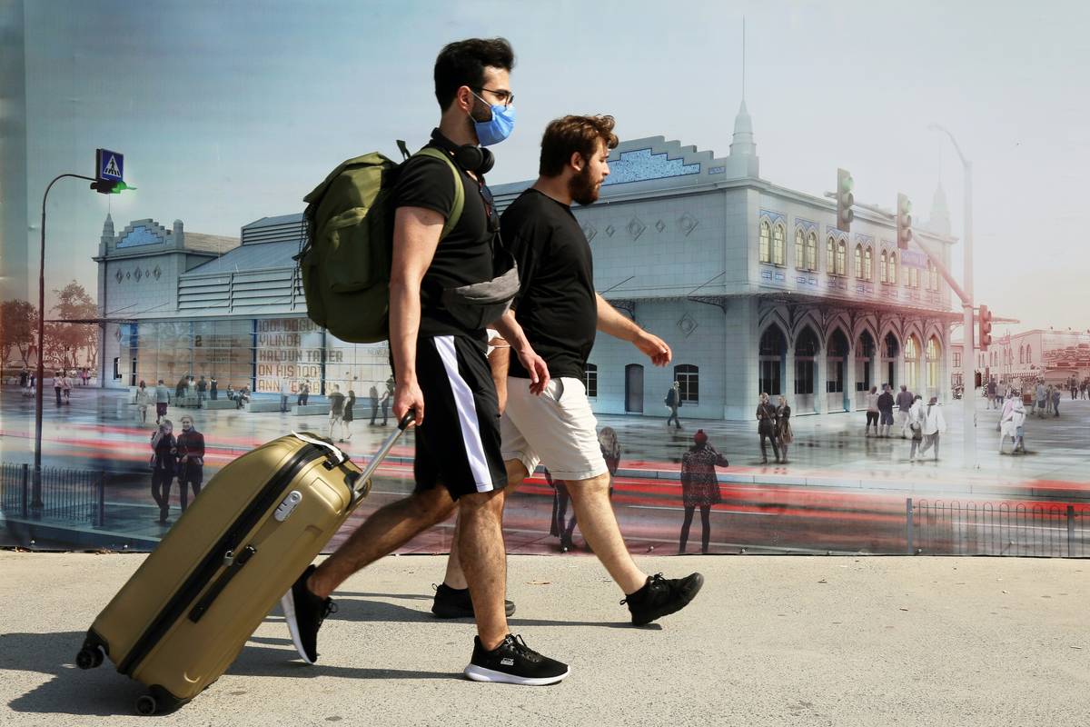 A traveler using a crisis repatriation phone while stranded overseas