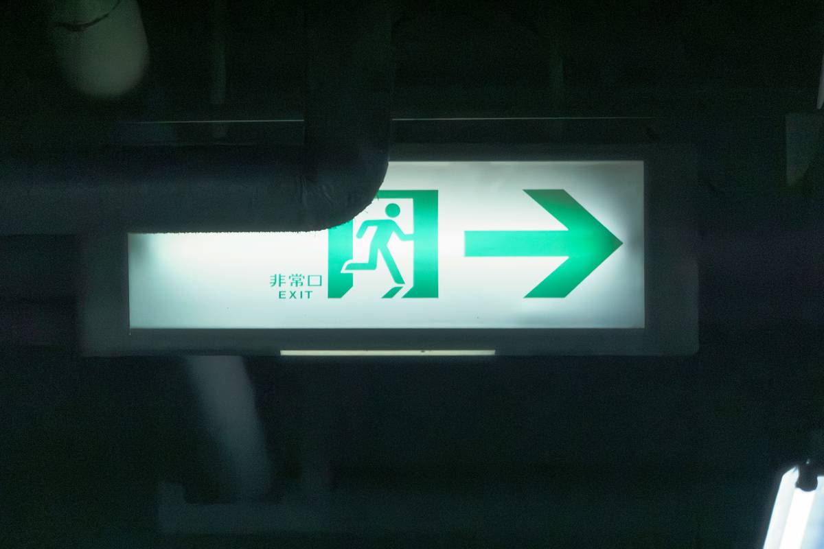 An air ambulance plane parked on a runway with medical staff boarding it.